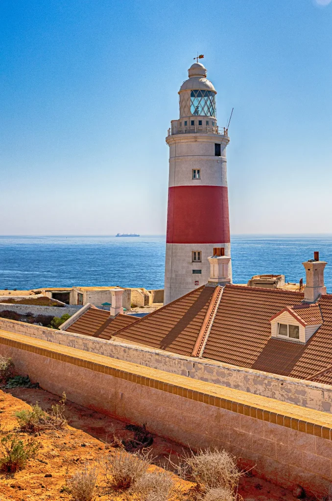 White and Red Lighthouse Beside Sea. Photo by Kent Kan.