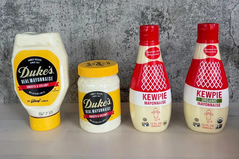 This image shows specialty condiments Duke’s Mayo, a century-old Southern classic, left, and Japanese Kewpie mayo. (Katie Workman via AP)